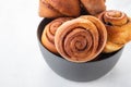 Cinnamon rolls buns in grey bowl. Macro focus Royalty Free Stock Photo