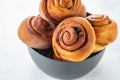 Cinnamon rolls buns in grey bowl. Macro focus Royalty Free Stock Photo