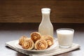 Cinnamon rolls with glass and bottle of milk Royalty Free Stock Photo