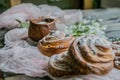 Cinnamon rolls with milk and flowers on a sunny day Royalty Free Stock Photo