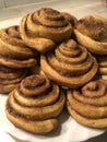 Cinnamon rolls on a plate on a beige table background