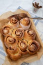 Cinnamon rolls with sugar frosting. With cinnamon sticks and spices, wooden background Royalty Free Stock Photo