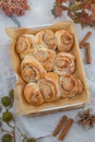 Cinnamon rolls with sugar frosting. With cinnamon sticks and spices, wooden background Royalty Free Stock Photo