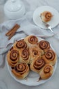 Cinnamon rolls with sugar frosting. With cinnamon sticks and spices, wooden background Royalty Free Stock Photo