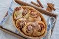 Cinnamon rolls with sugar frosting. With cinnamon sticks and spices, wooden background Royalty Free Stock Photo