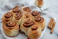 Cinnamon rolls with sugar frosting. With cinnamon sticks and spices, wooden background Royalty Free Stock Photo