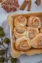 Cinnamon rolls with sugar frosting. With cinnamon sticks and spices, wooden background Royalty Free Stock Photo