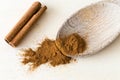 Cinnamon bark stick and ground powder spice on wooden spoon Royalty Free Stock Photo