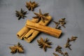 Cinnamon  star anise and cloves scattered on a gray background Royalty Free Stock Photo