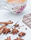 Cinnamon stick, star anise, bar of chocolate and cup of tea Royalty Free Stock Photo