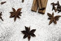 Cinnamon sticks and anise stars closeup on powdered sugar table. Cooking and baking background. Aromatic condiment and spices. Royalty Free Stock Photo