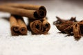 Cinnamon sticks and anise stars closeup on powdered sugar table. Cooking and baking background. Aromatic condiment and spices. Royalty Free Stock Photo