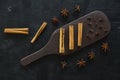 Cinnamon sticks and anise stars spices on roasted coffee beans background. With Wooden board. Royalty Free Stock Photo
