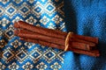 Cinnamon sticks on blue and gold background