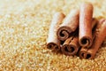 Cinnamon sticks on brown cane sugar Royalty Free Stock Photo