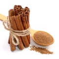 Cinnamon sticks bunch with powder on white background. Top view Royalty Free Stock Photo