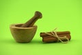 Cinnamon sticks bundle and wooden mortar with pestle Royalty Free Stock Photo