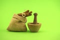 Cinnamon sticks bundle and wooden mortar with pestle Royalty Free Stock Photo