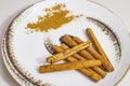 Cinnamon sticks and cinnamon powder on a plate Royalty Free Stock Photo