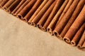 Cinnamon sticks on craft paper. Diagonal composition, closeup. Spicy ingredient for cooking, aromatherapy. Horizontal banner with