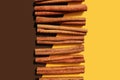 Cinnamon sticks on double background. Vanilla and chocolate concept. Deep yellow, brown. Topping for desserts, food. Natural