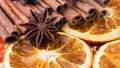 Cinnamon sticks, Dried citrus orange slices and Anise stars, background. Aromatic spices for Drink, cooking or baking. Royalty Free Stock Photo