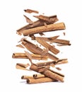 Cinnamon sticks are falling down on a pile,isolated on a white background