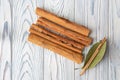 Cinnamon sticks natural spice and leaf on wooden background Royalty Free Stock Photo