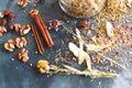 Cinnamon sticks, nuts and a herb collection scattered on a blue Royalty Free Stock Photo