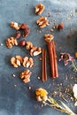 Cinnamon sticks, nuts and a herb collection scattered on a blue Royalty Free Stock Photo