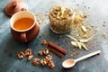 Cinnamon sticks, nuts and a herb collection scattered on a blue Royalty Free Stock Photo