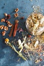 Cinnamon sticks, nuts and a herb collection scattered on a blue