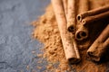 Cinnamon sticks and cinnamon powder on black slate plate Royalty Free Stock Photo