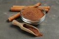 Cinnamon sticks and powder on grey table Royalty Free Stock Photo