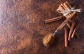 Cinnamon sticks and powder in spoon on a old copper table . Royalty Free Stock Photo