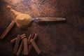 Cinnamon sticks and powder in spoon on a old copper table . Royalty Free Stock Photo