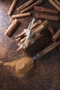 Cinnamon sticks and powder in spoon on a old copper table Royalty Free Stock Photo