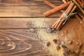 Cinnamon sticks, powder and sugar on wooden background Royalty Free Stock Photo