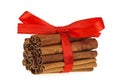 Cinnamon sticks with red ribbon on white background Royalty Free Stock Photo