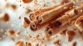 Cinnamon Sticks with small Crumbs fall on light yellow blurred background. Creative concept of floating and falling spyce Royalty Free Stock Photo