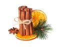 Cinnamon sticks, star anise, cloves and dried orange with artificial spruce twigs isolated on white