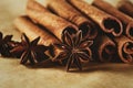 Cinnamon sticks and three stars anise on brown paper background Royalty Free Stock Photo