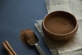 Cinnamon sticks, tied with jute rope in rustic style. Ground cinnamon in a wooden bowl and vintage scoop. Close up on a Royalty Free Stock Photo