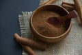 Cinnamon sticks, tied with jute rope in rustic style. Ground cinnamon in a wooden bowl and vintage scoop. Close up on a Royalty Free Stock Photo