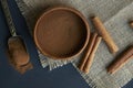 Cinnamon sticks, tied with jute rope in rustic style. Ground cinnamon in a wooden bowl and vintage scoop. Close up on a Royalty Free Stock Photo