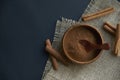 Cinnamon sticks, tied with jute rope in rustic style. Ground cinnamon in a wooden bowl and vintage scoop. Close up on a Royalty Free Stock Photo