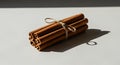 Cinnamon sticks tied with twine, casting a shadow on a white surface Royalty Free Stock Photo