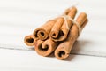 Cinnamon sticks tied up in bundle on white wooden background. Royalty Free Stock Photo