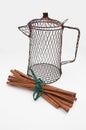 Cinnamon sticks and wire coffee pot still life