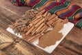 Cinnamon sticks on a wooden background. Cinnamon spice in a spoon and bowl. Ceylon cinnamon. Cinnamon dried bark strips and Royalty Free Stock Photo